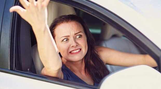 Northern Irish woman gives the one-fingered salute in an awkward exchange with cops in an unmarked police car